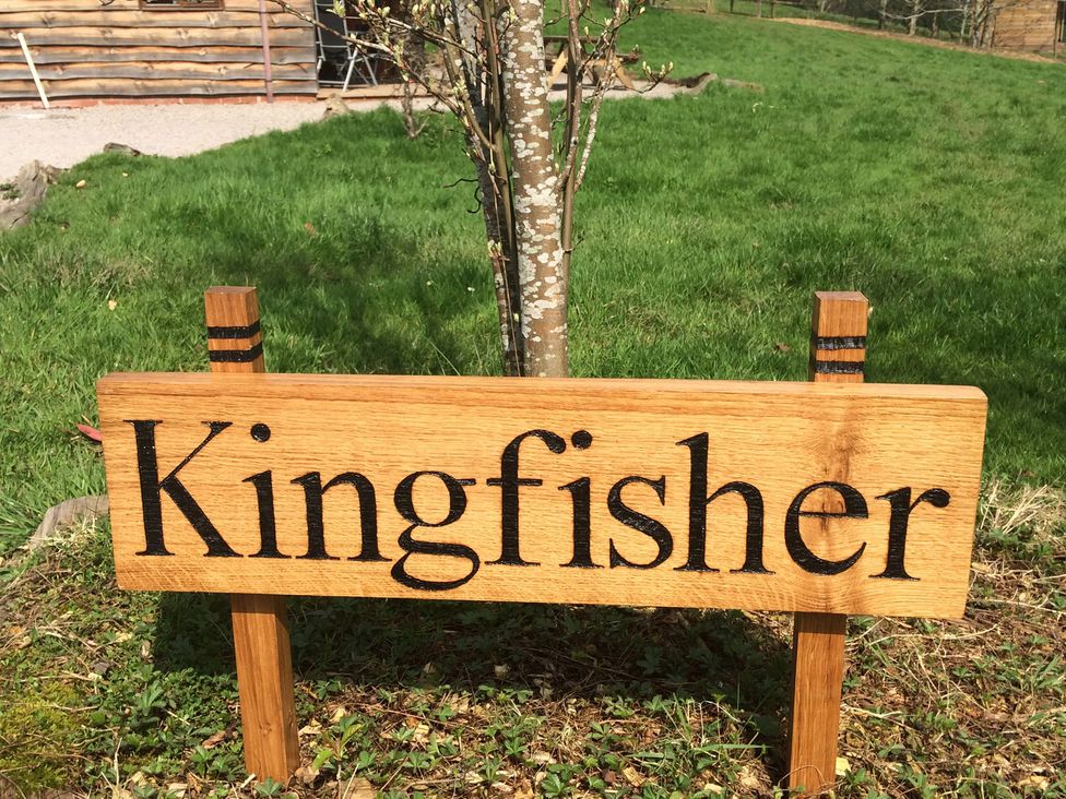 A wooden sign saying Kingfisher in an outdoor area at Kingfisher in Worcester