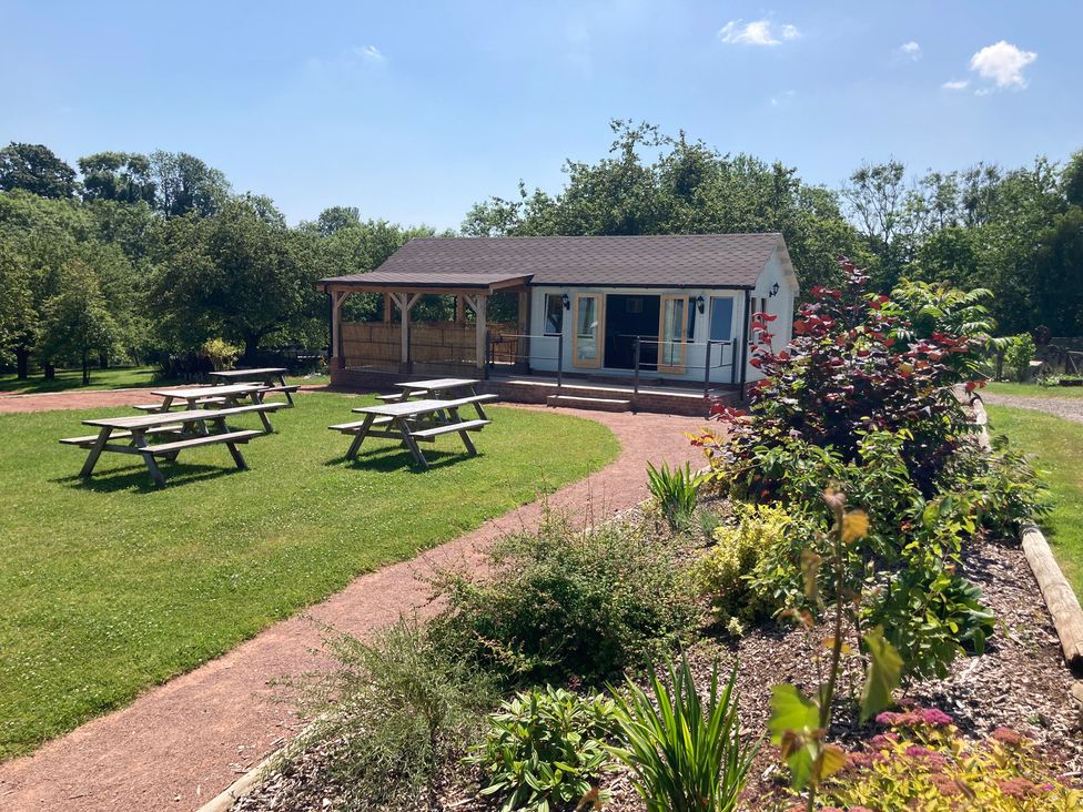 A building with tables and benches outdoors at Kingfisher in Worcester