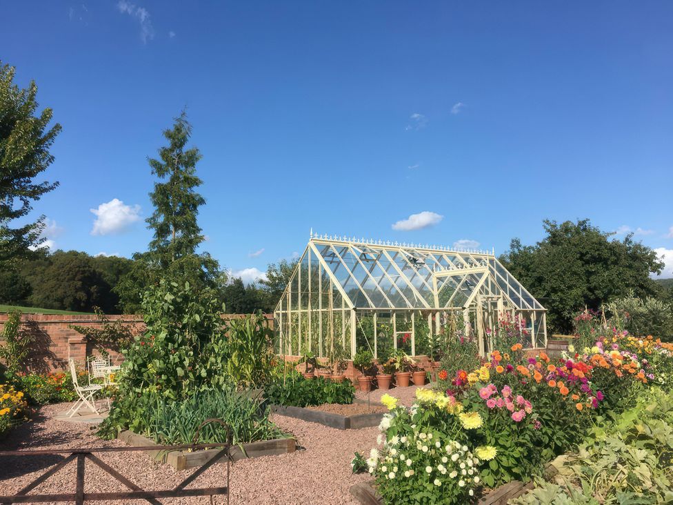 A greenhouse surrounded by flowers at Kingfisher in Worcester