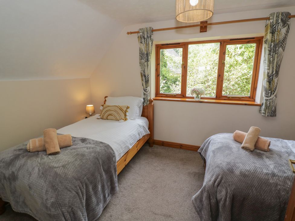 A bedroom with two beds and a window at Kingfisher in Worcester