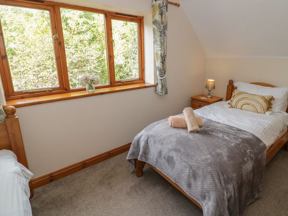 A bedroom with a bed and a bedside table at Kingfisher in Worcester
