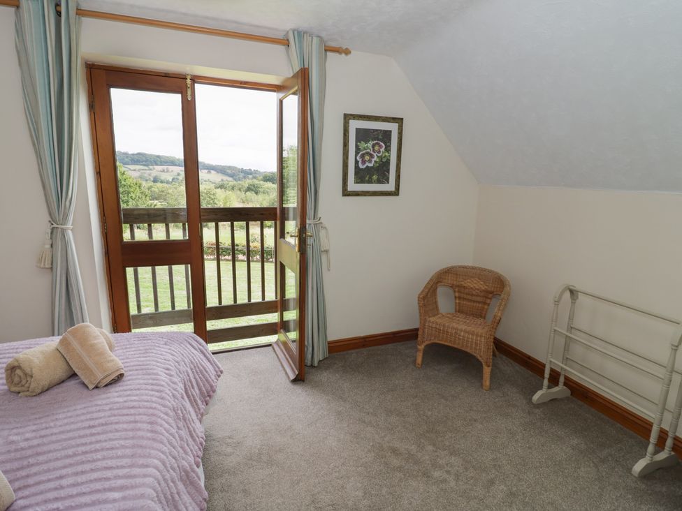 A bedroom with a door leading to a balcony at Kingfisher Worcester