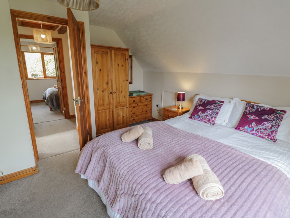 A bedroom with a bed and wardrobe at Kingfisher in Worcester