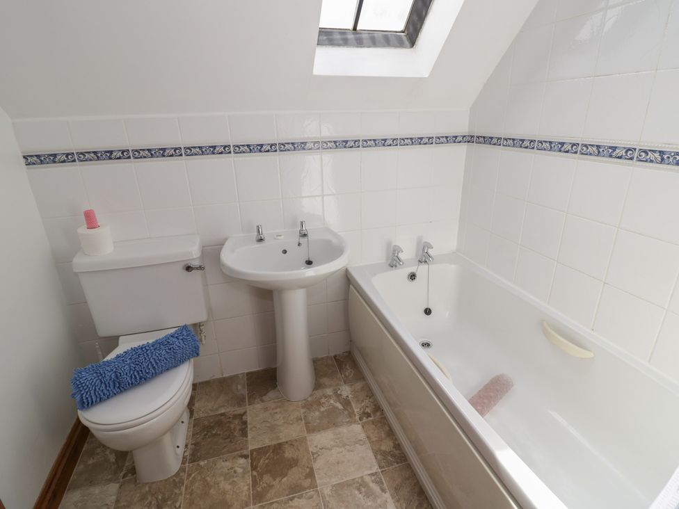 A bathroom with toilet, sink, and bathtub at Kingfisher in Worcester