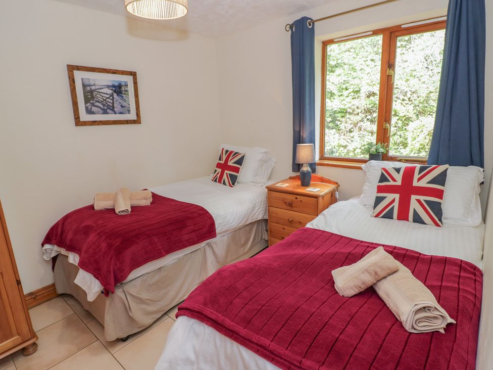 A bedroom with two beds and a window at Kingfisher in Worcester