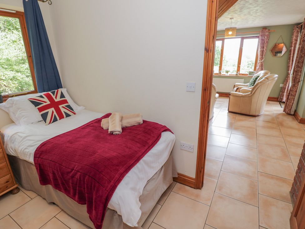 A bedroom with a bed and window at Kingfisher in Worcester