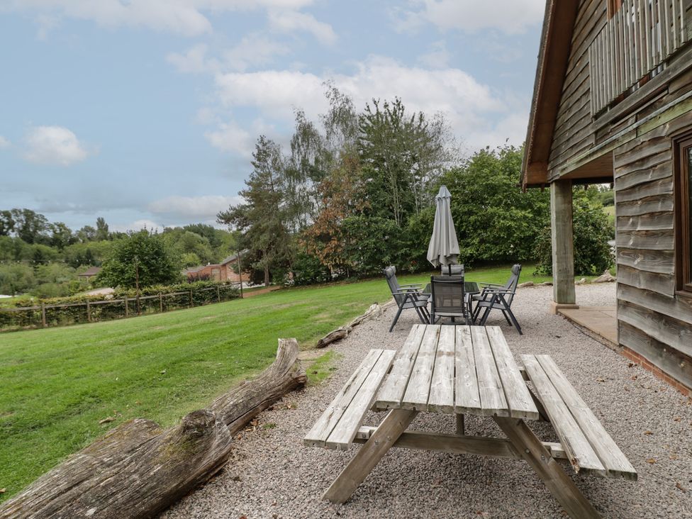 A table with chairs and an umbrella in an outdoor area at Kingfisher, Worcester