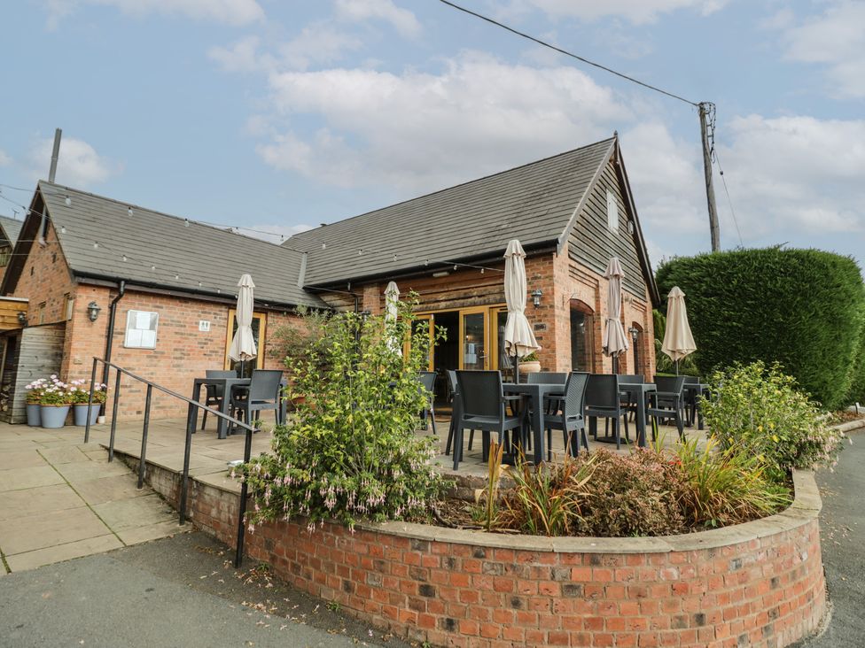 An outdoor seating area with tables and chairs at Kingfisher in Worcester