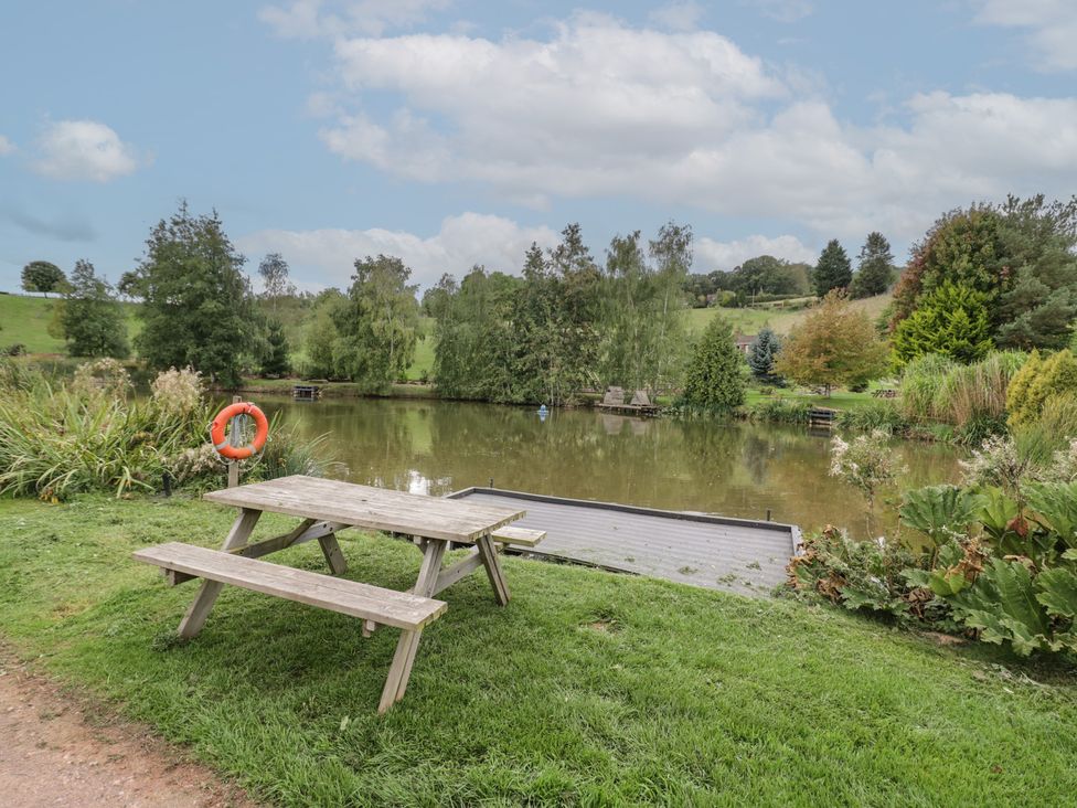 A picnic table beside a lake at Kingfisher in Worcester