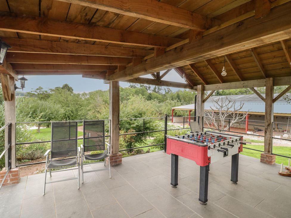An outdoor area with a foosball table and chairs at Kingfisher in Worcester