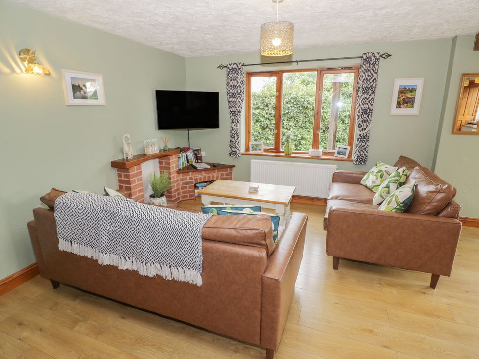A living room with sofas and a television at Heron in Worcester