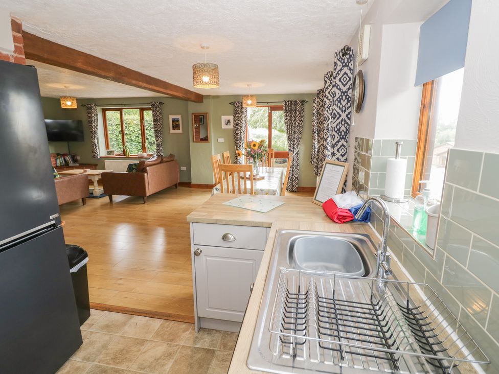 A kitchen with a sink and dining area at Heron in Worcester