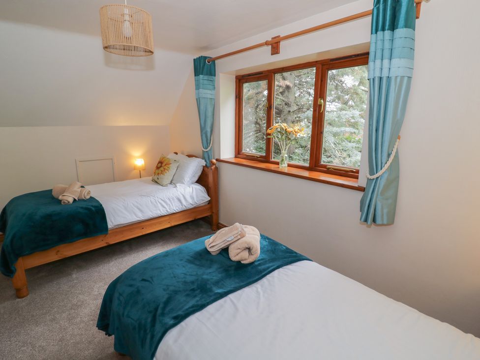 A bedroom with two single beds and a window at Heron in Worcester