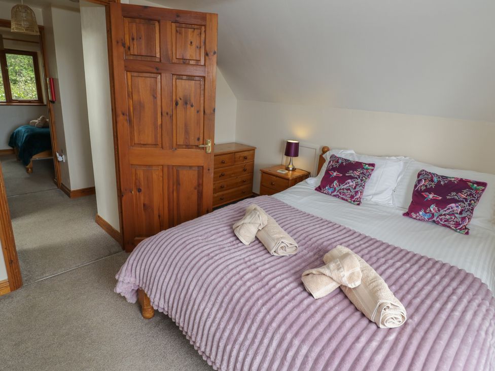A bedroom with a bed and nightstand at Heron in Worcester