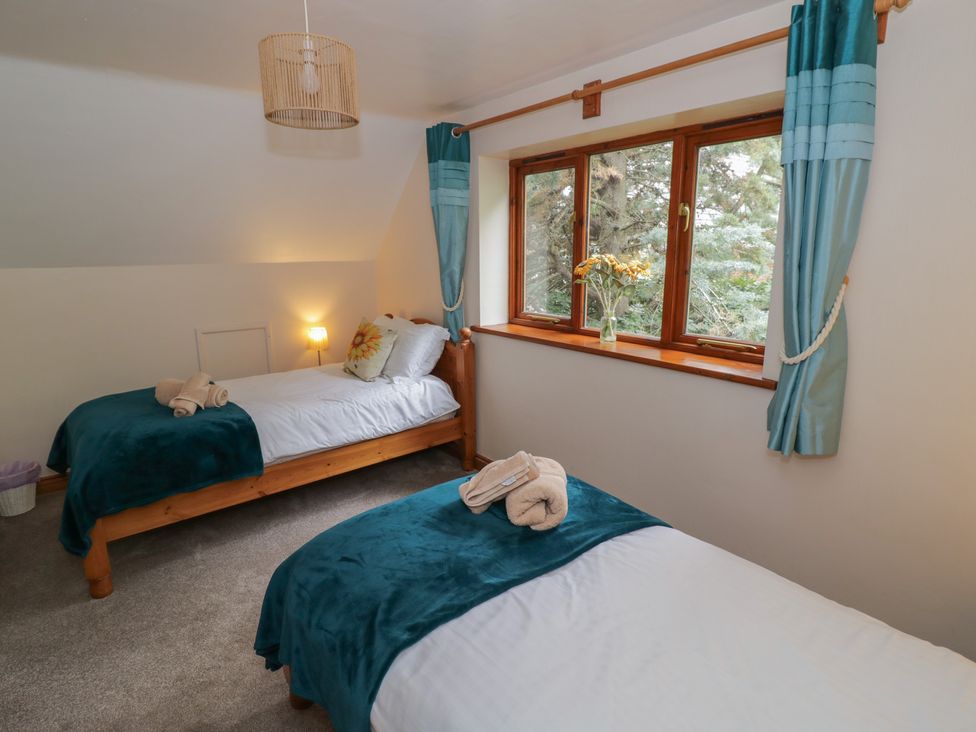 A bedroom with two beds and a window at Heron in Worcester