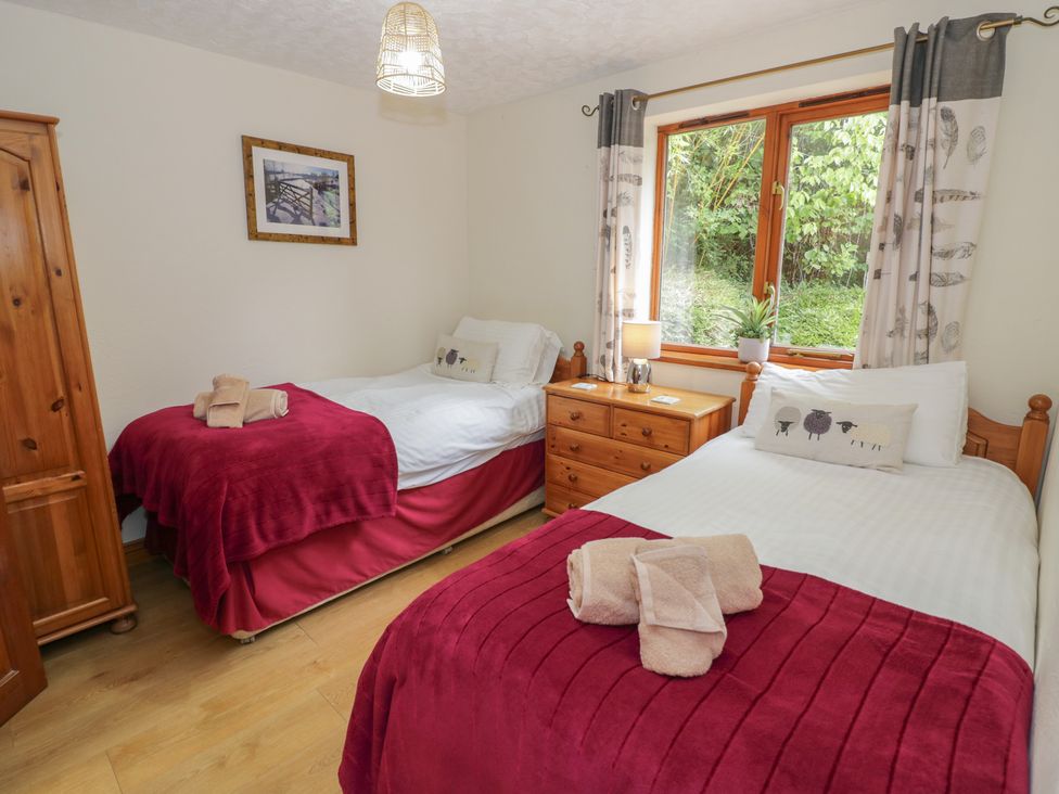 A bedroom with two single beds and a window at Heron in Worcester