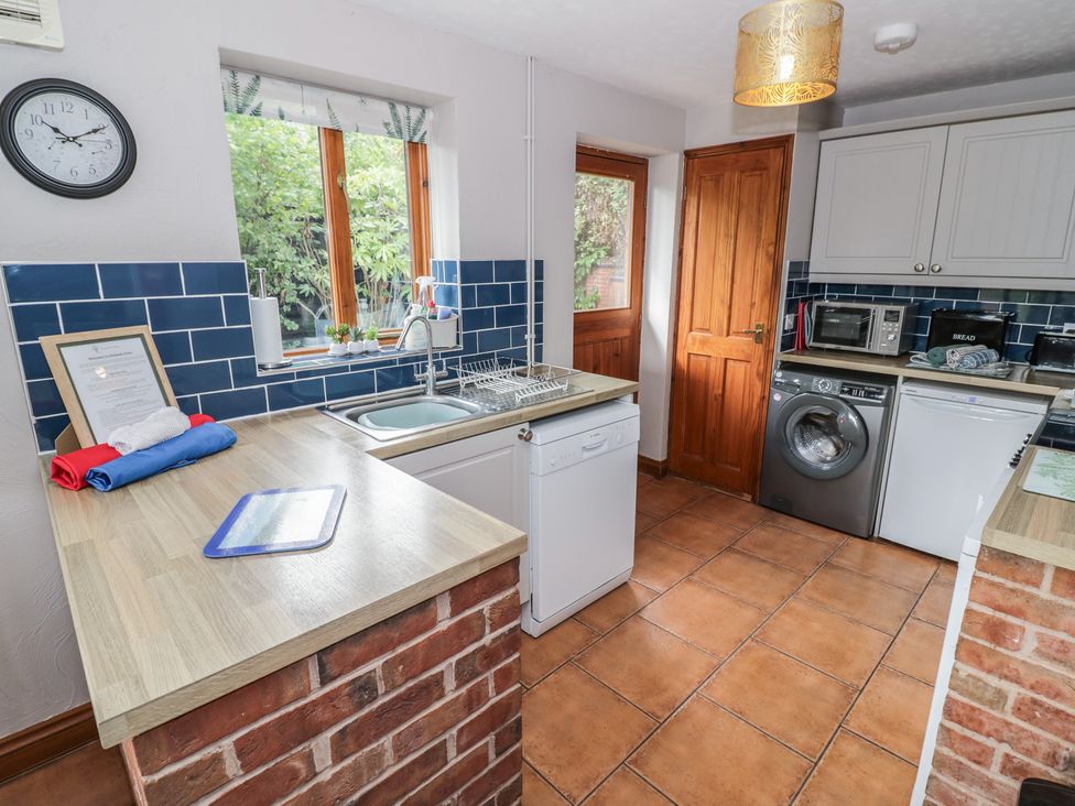 A kitchen with appliances and a window at Woodpecker in Worcester