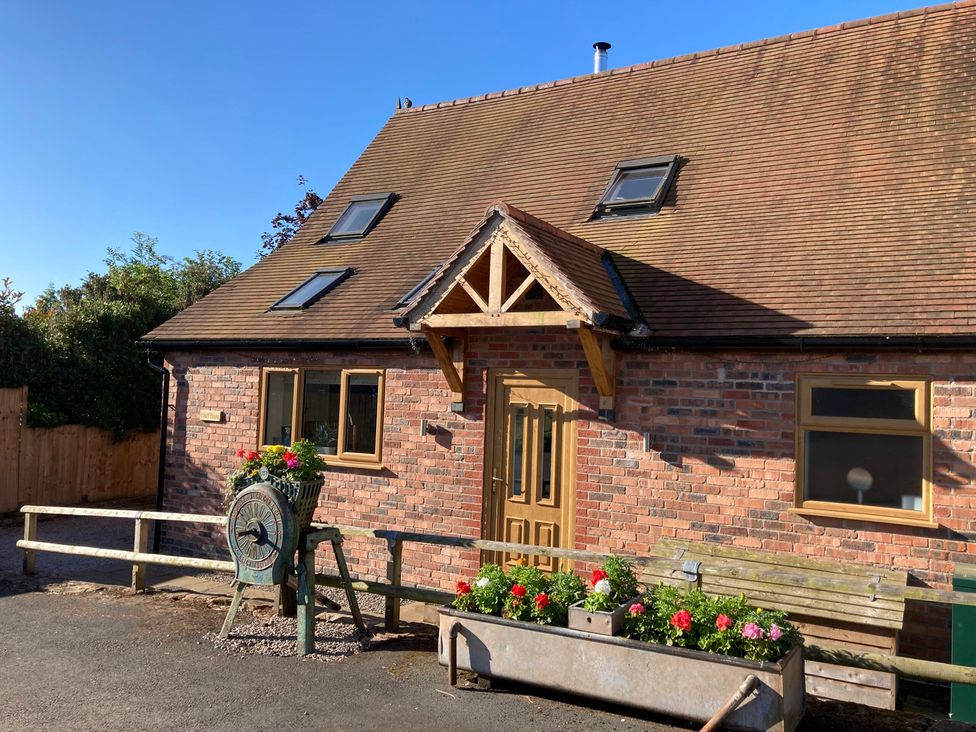 A house with a wooden door and flower planter at Chaff House Worcester
