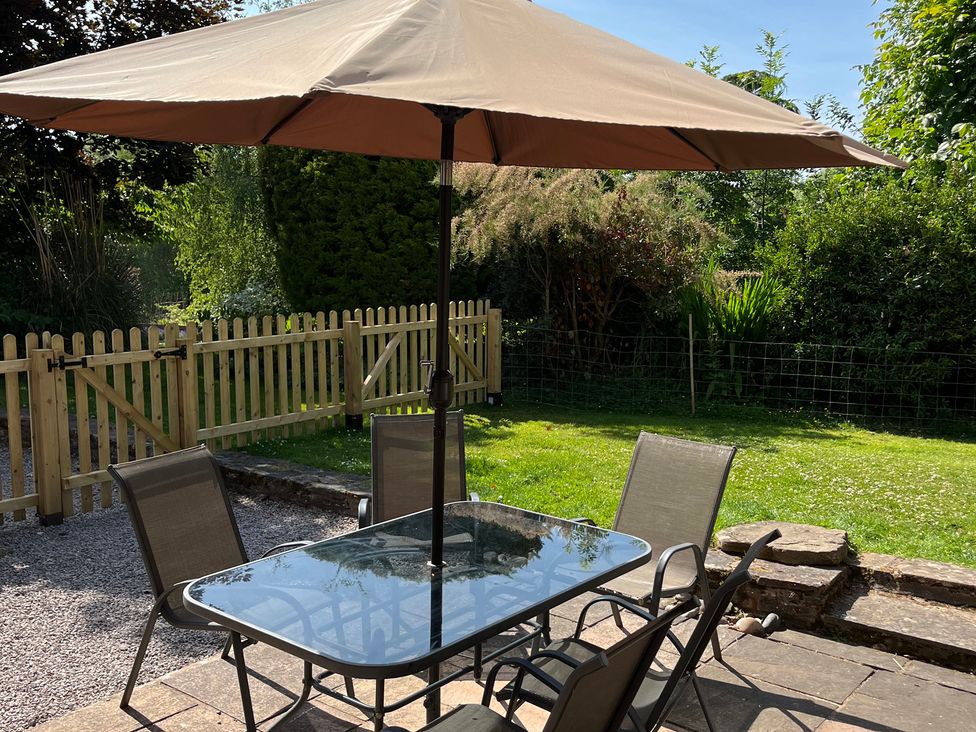 An outdoor dining area with a table and chairs at Chaff House Worcester