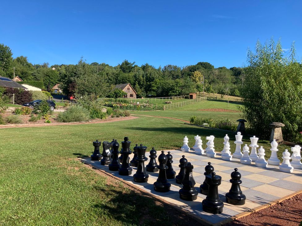A chess set in a garden with grass and trees at Chaff House in Worcester