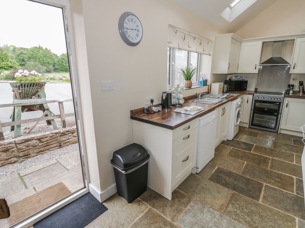A kitchen with a sink and stove at Chaff House Worcester