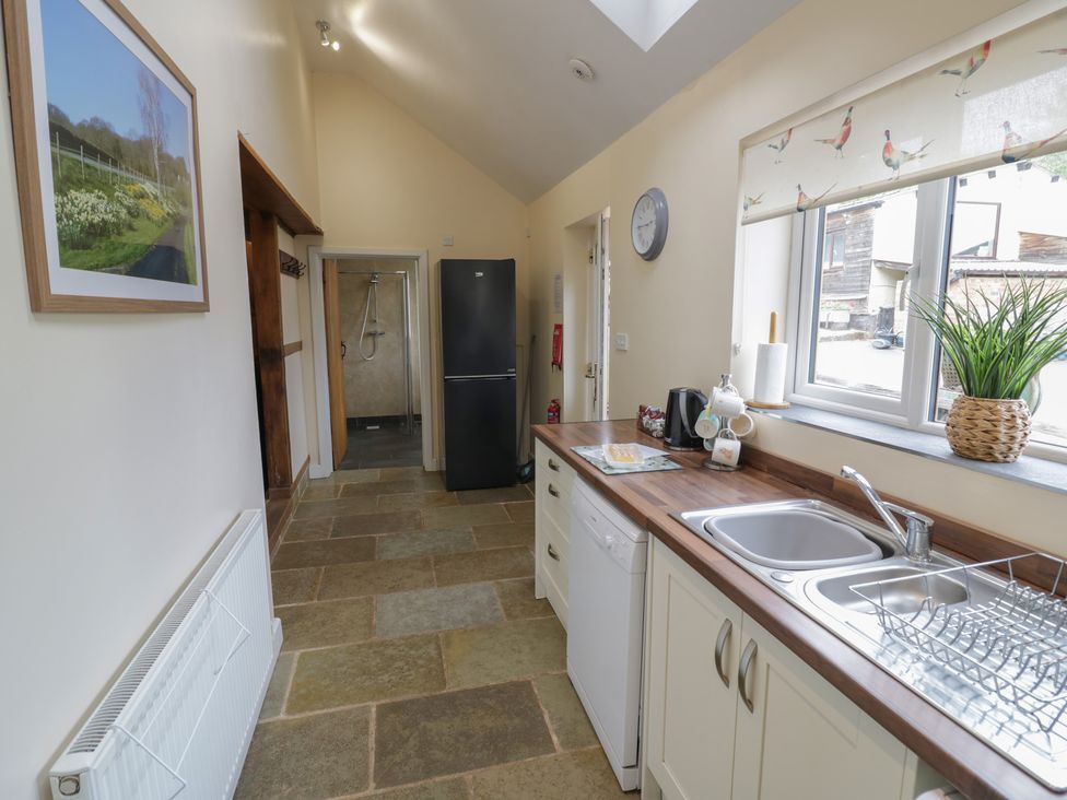 A kitchen with a sink and refrigerator at Chaff House in Worcester
