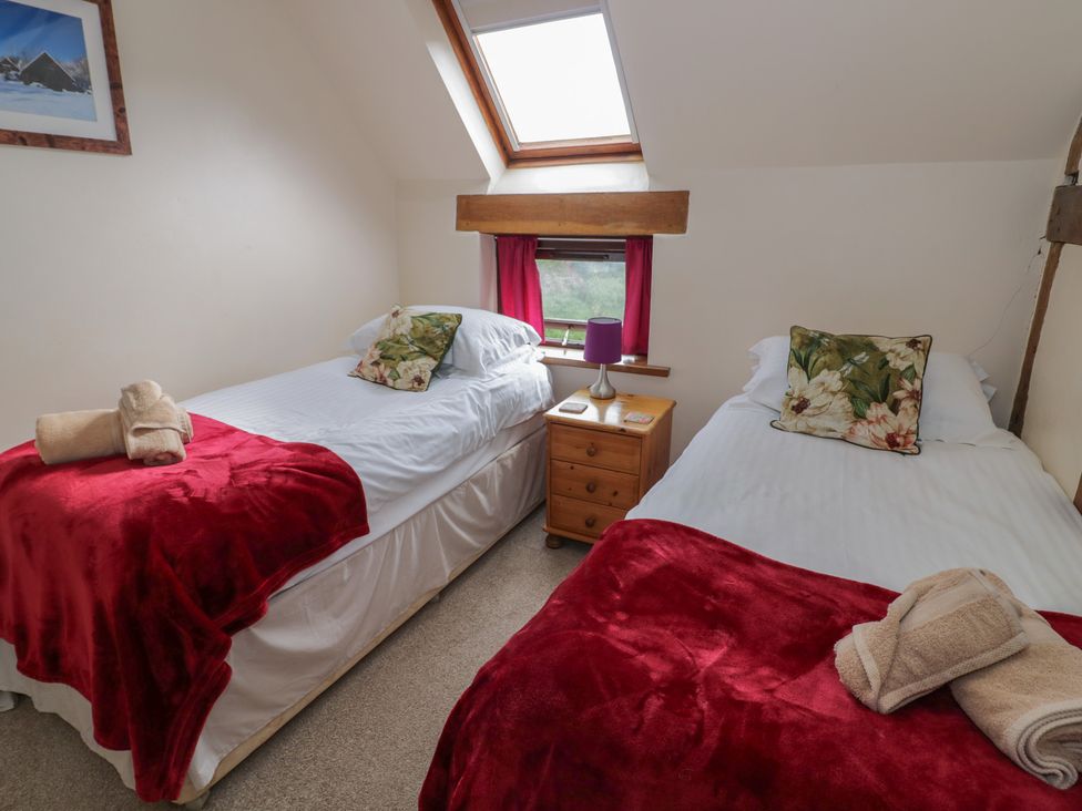 A bedroom with two single beds and a window at Chaff House in Worcester