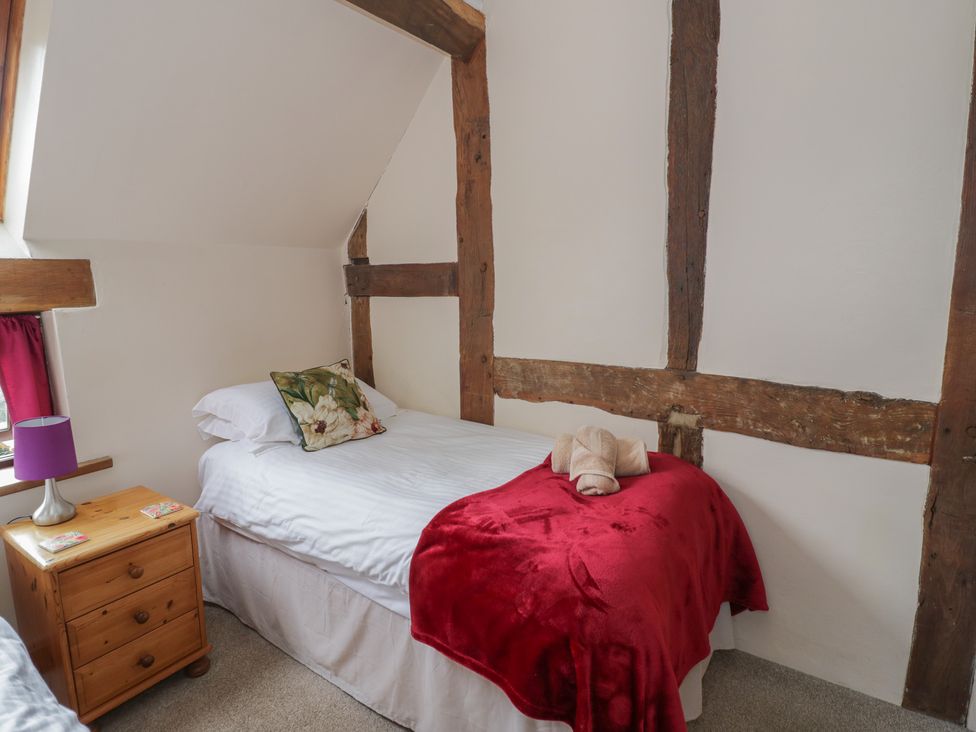 A bedroom with a single bed and wooden elements at Chaff House in Worcester