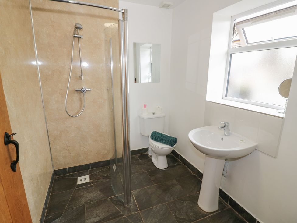 A bathroom with shower, toilet, and sink at Chaff House Worcester