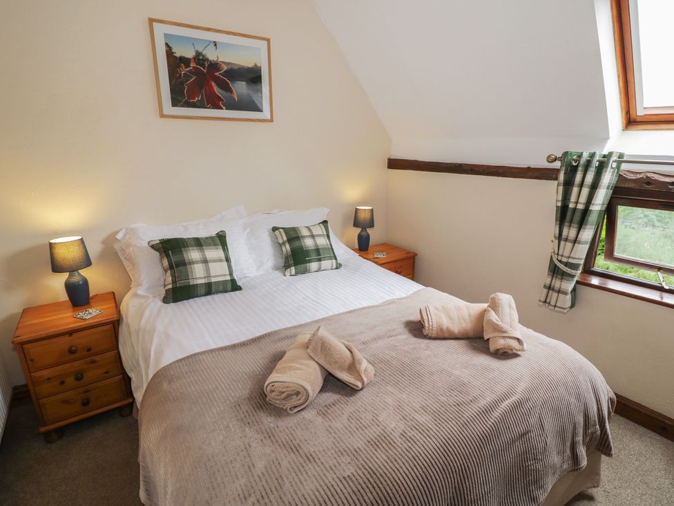 A bedroom with a bed and bedside tables at Chaff House in Worcester