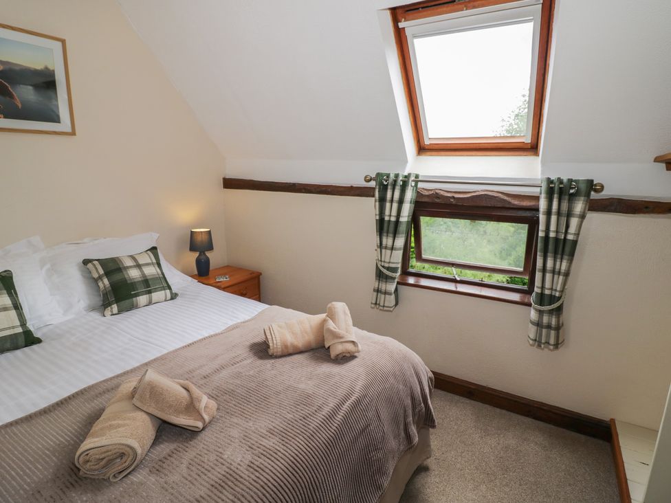A bedroom with a bed, pillows, and window at Chaff House in Worcester