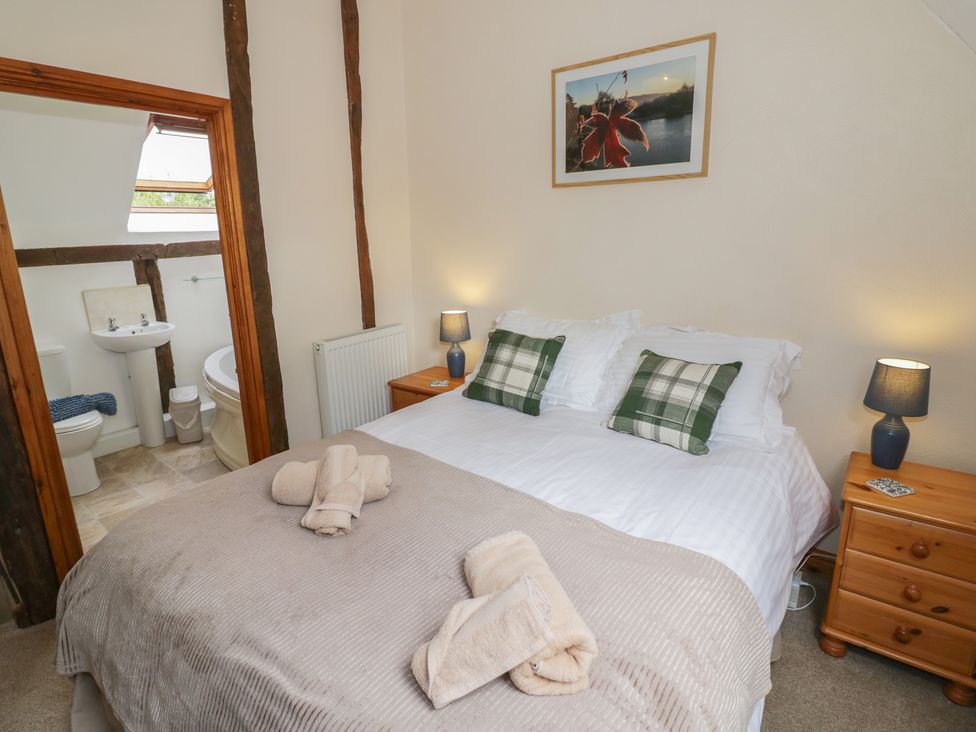 A bedroom with a double bed and bathroom view at Chaff House in Worcester