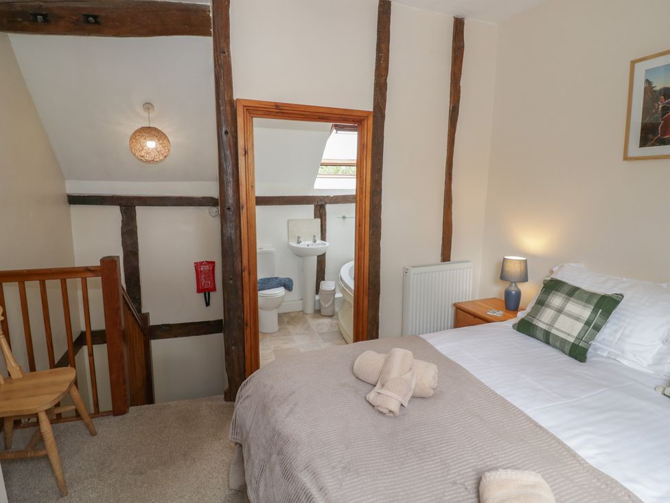 A bedroom with a bed and adjoining bathroom at Chaff House in Worcester