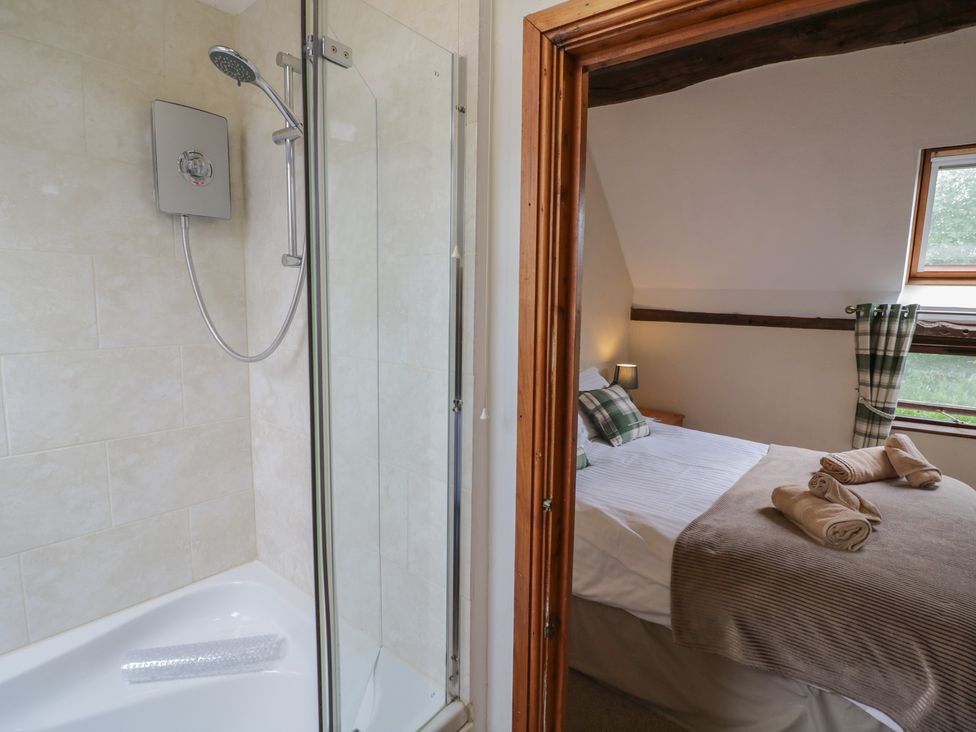 A bathroom with a shower and a view of a bedroom at Chaff House in Worcester