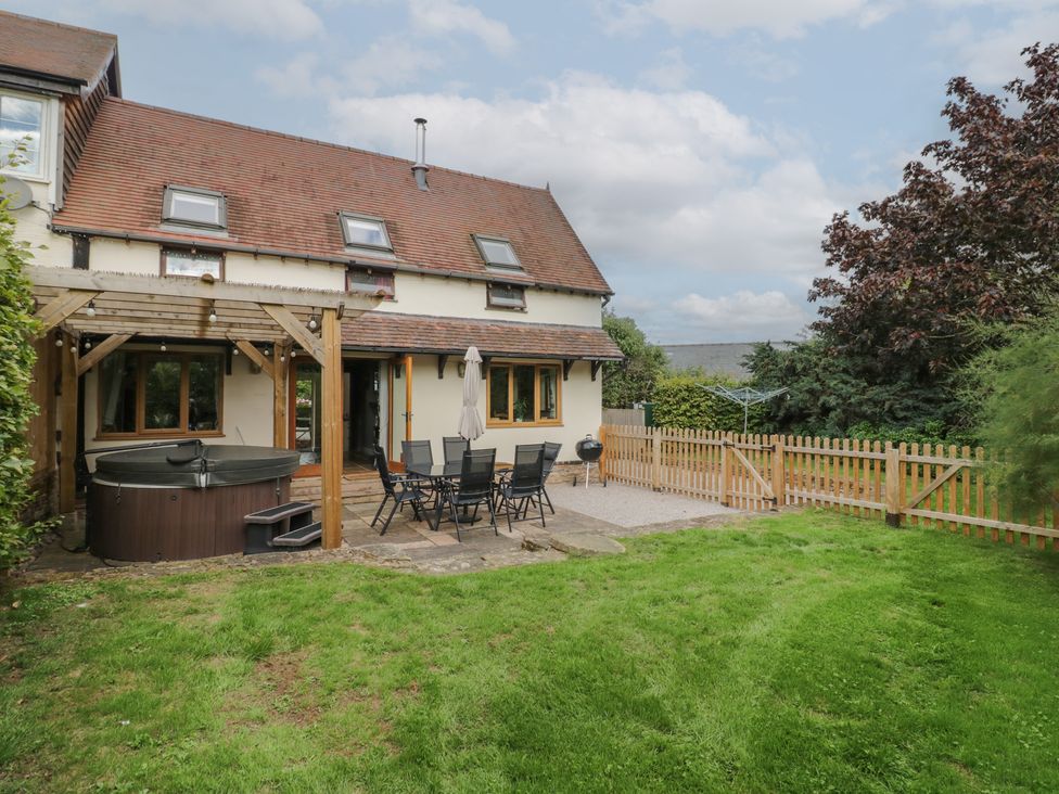 A garden with a hot tub and dining set at Chaff House in Worcester