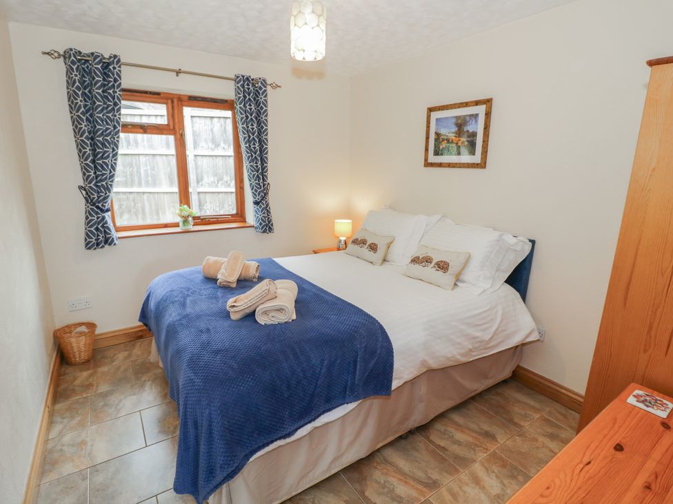 A bedroom with a double bed and a dresser at Pippin in Worcester