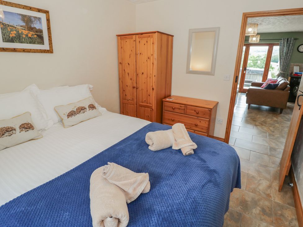 A bedroom with a bed and wardrobe at Pippin Worcester
