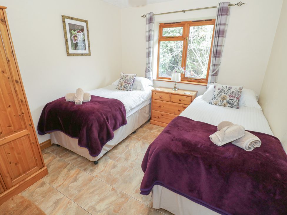 A bedroom with two single beds and a dresser at Pippin in Worcester