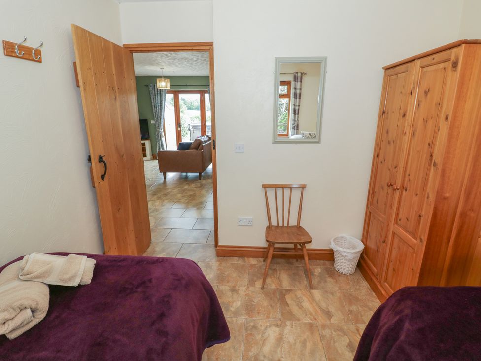 A bedroom with two beds and a chair at Pippin in Worcester