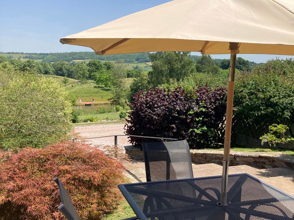 An outdoor seating area with a table and chairs at Russet in Worcester