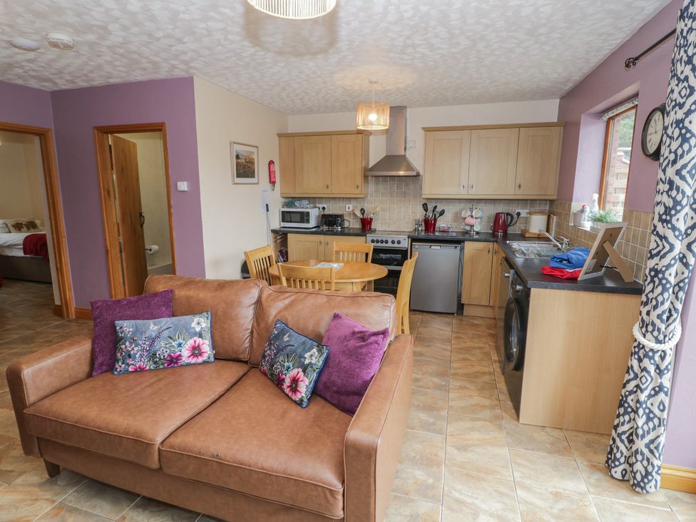 A kitchen with a couch and dining table at Russet in Worcester