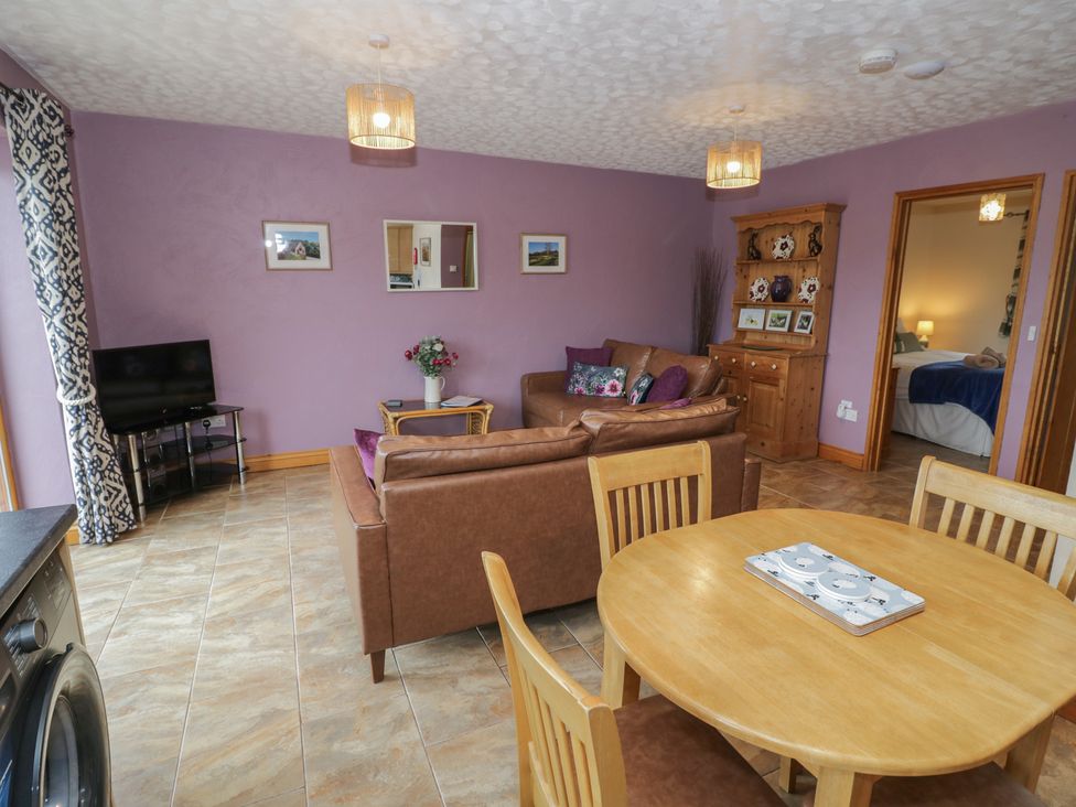 A living room with a sofa and dining table at Russet in Worcester