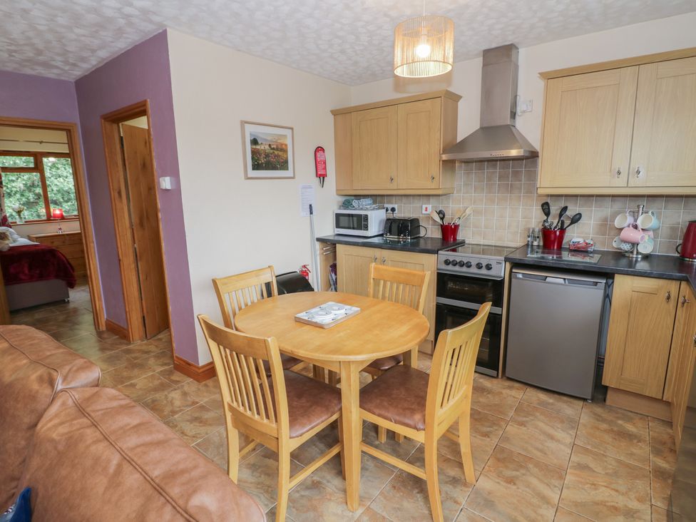 A kitchen with a table and chairs at Russet in Worcester