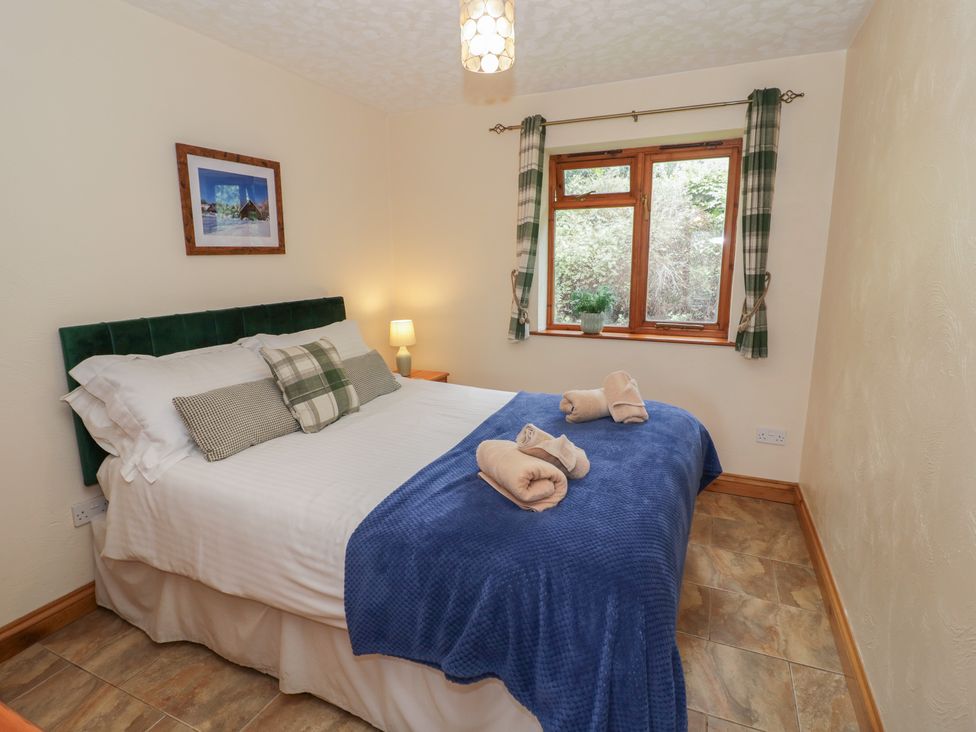A bedroom with a bed and window at Russet in Worcester