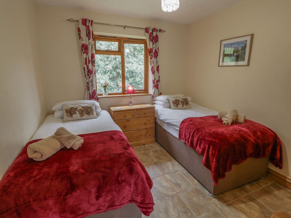 A bedroom with two single beds and a window at Russet in Worcester