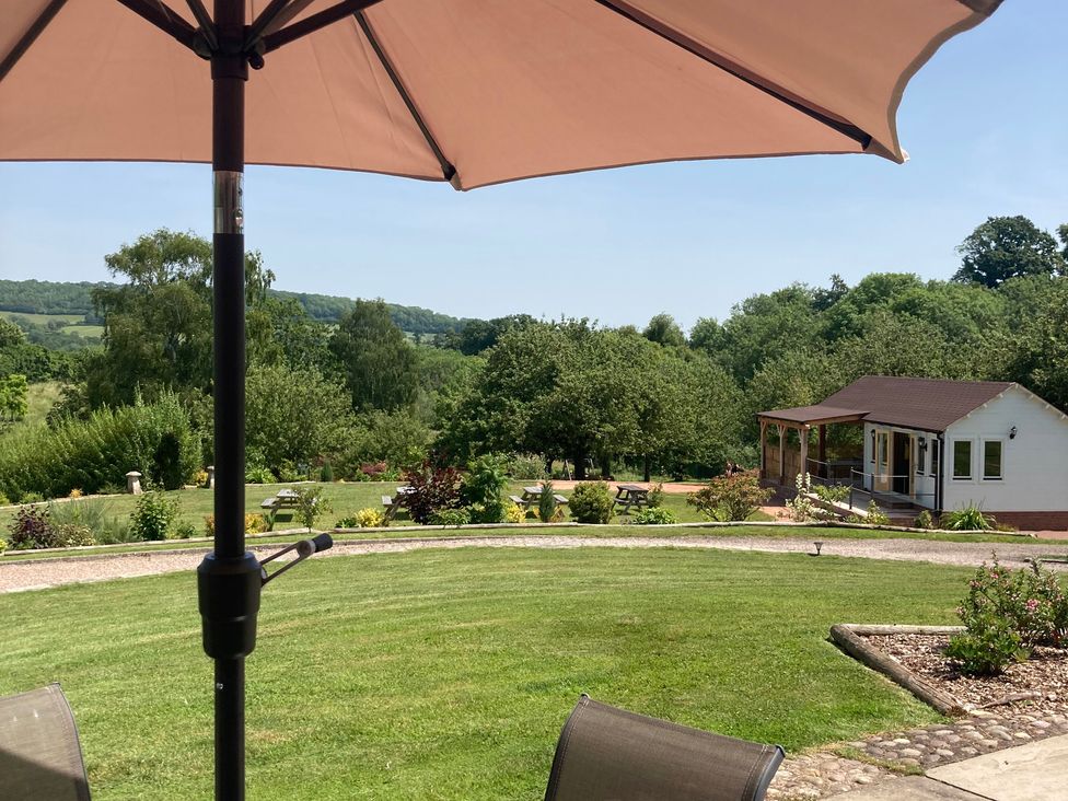 A garden with seating area and a shed at Bramley in Worcester