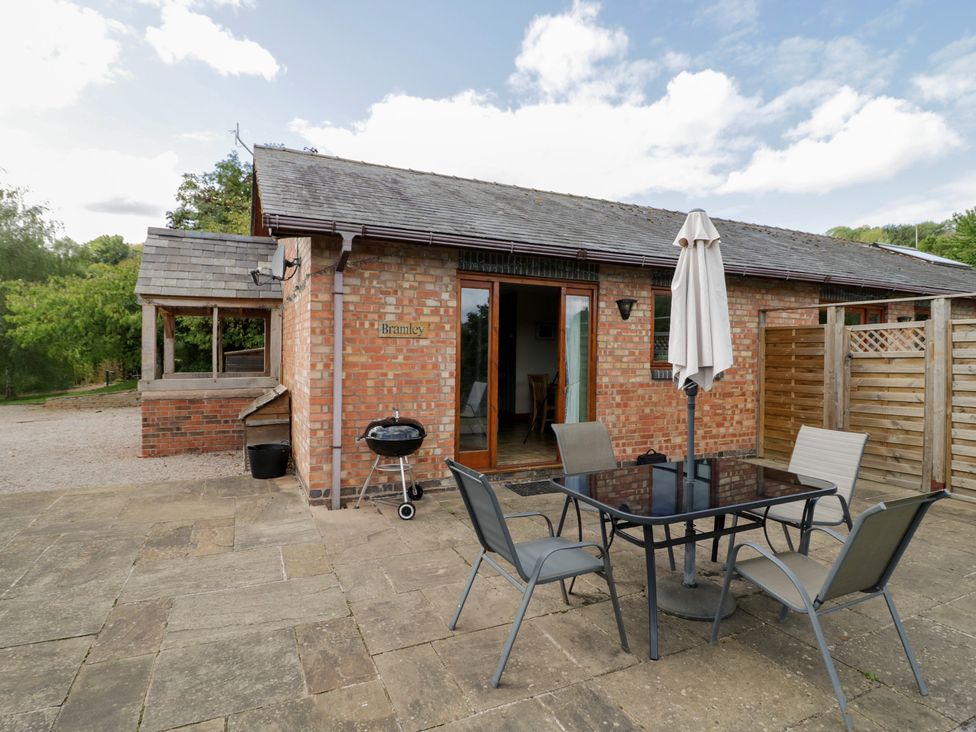 An outdoor seating area with a table and chairs at Bramley in Worcester