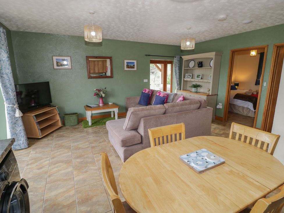 A living room with a sofa and dining table at Bramley in Worcester