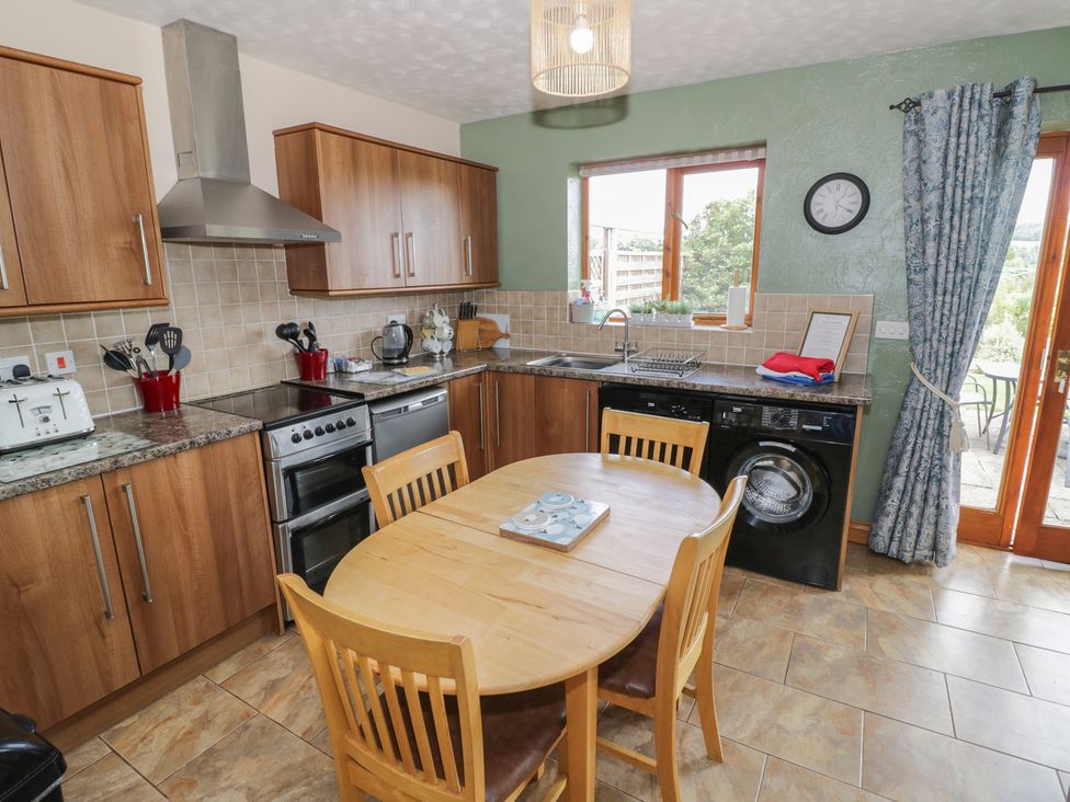 A kitchen with wood cabinets and appliances at Bramley in Worcester