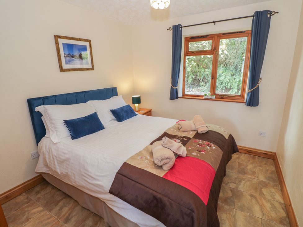 A bedroom with a bed and bedside table at Bramley in Worcester